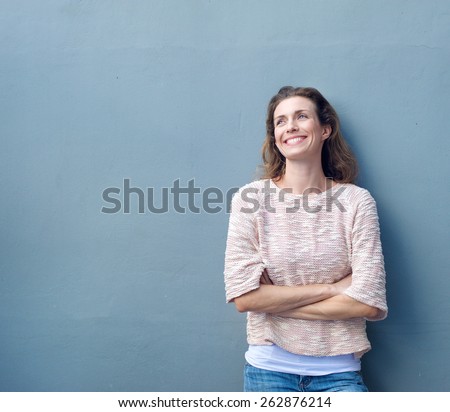 Portrait of a beautiful natural woman smiling with arms crossed