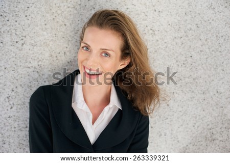 Close up portrait of a happy business woman laughing with black jacket and white shirt