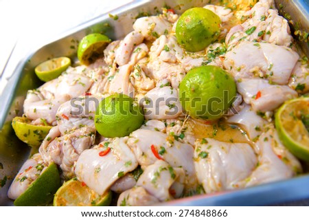 Close up raw chicken in lemon and chilly marinade