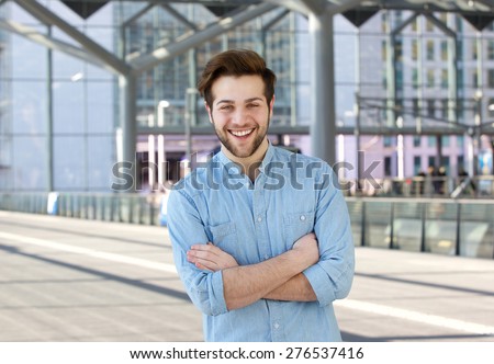 Close up portrait of a cool guy smiling with arms crossed