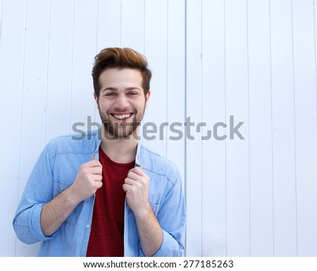 Portrait of a happy young man with beard posing against white background