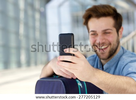 Close up portrait of a cool young guy taking selfie with mobile phone