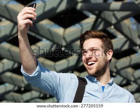 Close up portrait of a cool guy taking selfie
