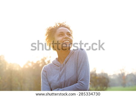 Portrait of a happy young woman thinking and looking up