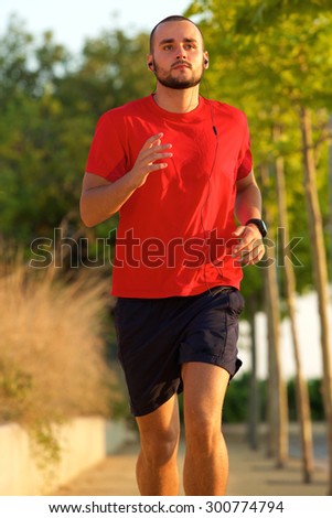 Young active man enjoying a jog outdoors