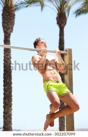 Strong young man pull up bar exercise workout routine