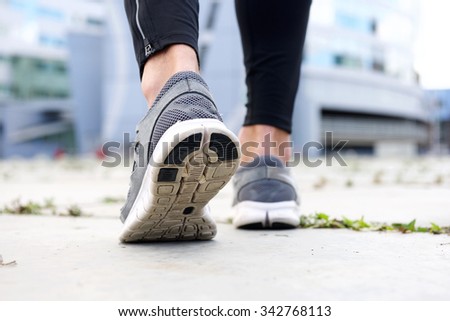 Low angle rear sport shoes walking outside