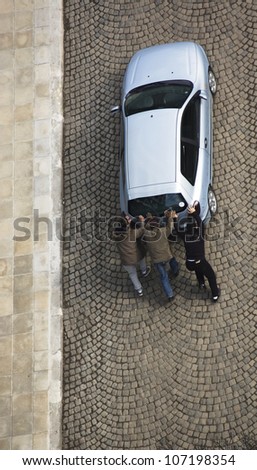 Men Pushing Car