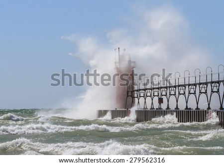 The Lake Michigan Lighthouse in South Haven gets pounded during a massive wind storm and waves flow over the 60 foot lighthouse and pier.