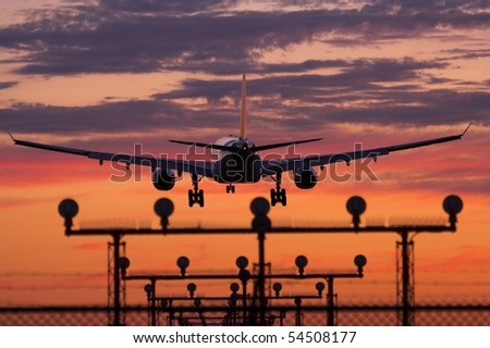 Airplane landing during sunset