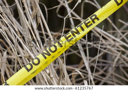 Do not enter yellow tape with a dry grass background