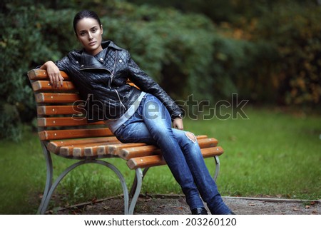 Fashion outdoor portrait of a sensual brunette in leather jacket.