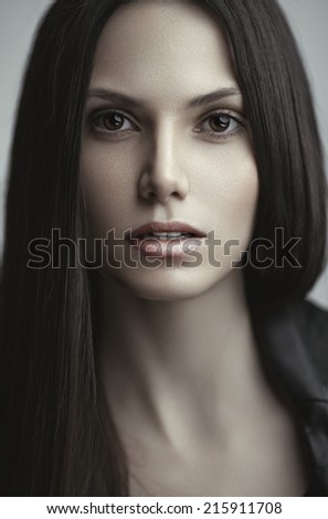 Beauty portrait of a young sensual model with long straight brown hair.