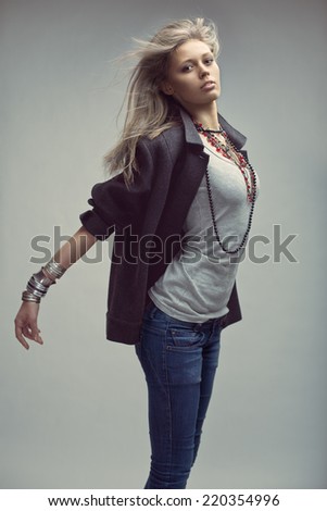 Fashion portrait of jumping blonde model with flying hair. Magnificent hair.