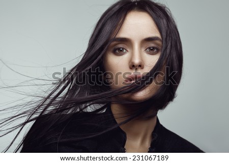 Beauty portrait of brunette girl with flying hair. Magnificent hair.