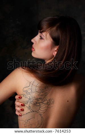 stock photo : Sexy brunette girl with dragon tattoo