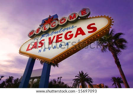 Famous Las Vegas Welcome Sign at sunset with palm trees in the background