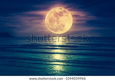Super moon. Colorful sky with cloud and bright full moon over seascape in the evening. Serenity nature background, outdoor at nighttime. Cross process. The moon taken with my own camera.