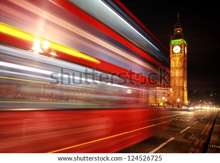 London night scene of Westminster and Big Ben with famous London bus driving by