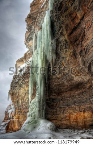 An hdr (high dynamic range) photo of extremely long icicles on a cliff at winter in Estonia
