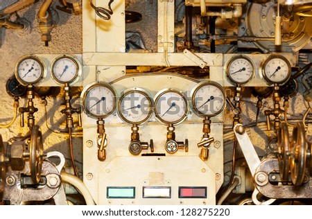 A photo of several indicators for measuring pressure of an engine. The photo is taken inside and old submarine called Lembit built just before the World War II.