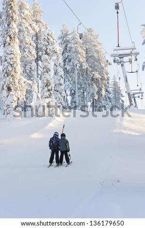 Children on ski elevator going up to the ski mountain