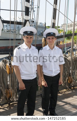 TALLINN, ESTONIA - JULY 12, 2013: Two crew members of the Kruzenshtern or Krusenstern sail ship in solid uniforms on July 12, 2013 in Tallinn, Estonia