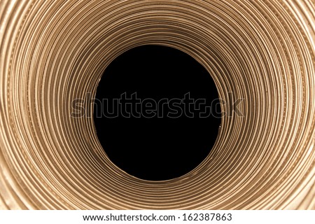 Illuminated round pipe and black hole at the end