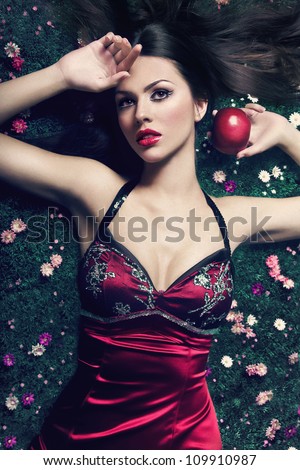 beautiful girl lie on a ground with apple in the hand. Snow White tale