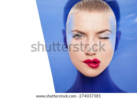 Fashion portrait of beautiful women under blue plastic. Make-up face-art cosmetic. wink