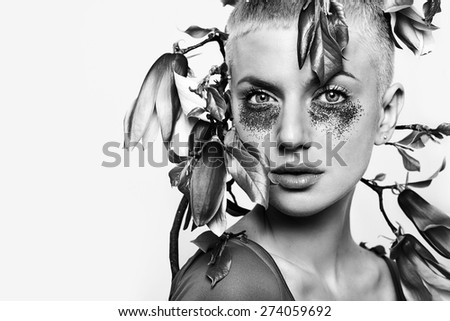 portrait of beautiful woman with pink glitter make-up and magnolia, black and white