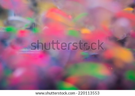 Abstract colorful background by defocus swimming fish in aquarium