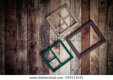 Empty wooden frame for photographer or painting hang on wooden wall