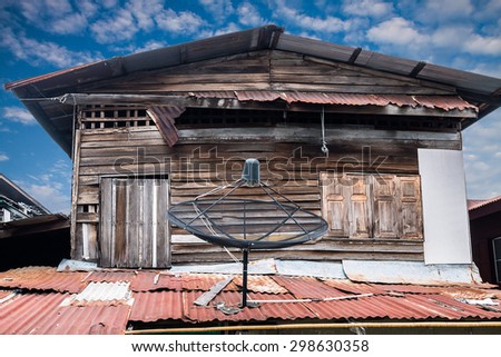 Satellite dish on roof of old house with blue sky in Bangkok,Thailand