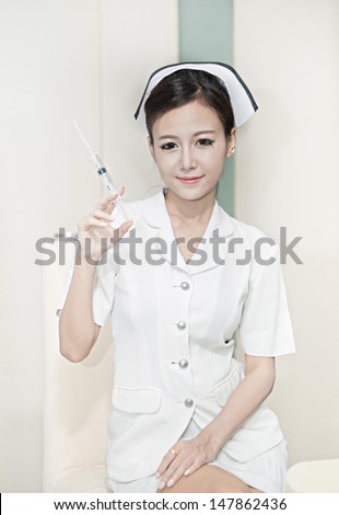 young sexy female Asian nurse in white uniform