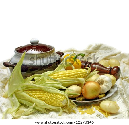 Soup vegetables, arranged with soup tureen and lace isolated on white