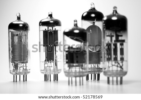 Agroup of vintage vacuum tubes dating back to the fifties. Only the tubes on left side are in focus.