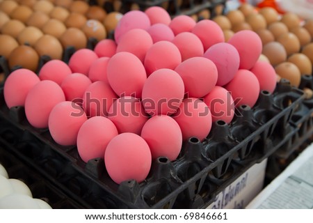 Red eggs for sale at a market in Thailand. Those red eggs are also called hundred-year  or pidan eggs and are part of traditional chinese cuisine.