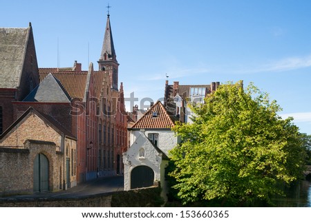Impressions of brickwall houses and a small church along a small river in the Venice of the North, Bruges in Belgium