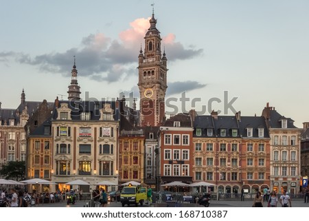LILLE, FRANCE - SEPTEMBER 5: View over the lively Place du General de Gaulle to the Belfry being one of the town\'s landmark at sunset. September 5th, 2013 in Lille, France