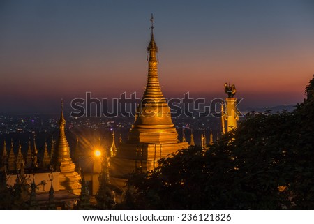 Sunset view from Mandalay hill at Su Taung Pyai Pagoda  down to the city over illuminated Chedis