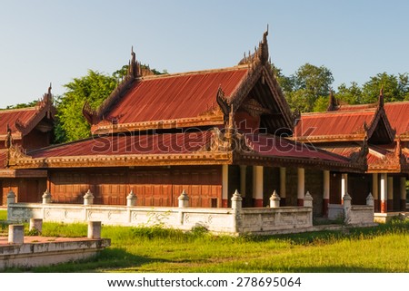 Well-preserved and/or reconstructed wooden buildings at the Mandalay Royal Palace compound seen at late afternoon sun