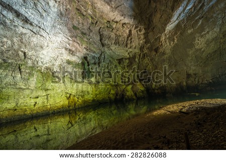 Underground river in Planina Cave situated nearby Postojna in Slovenia. Inside this large Karst Cave is a confluence of two underground rivers, Pivka and Rak River.
