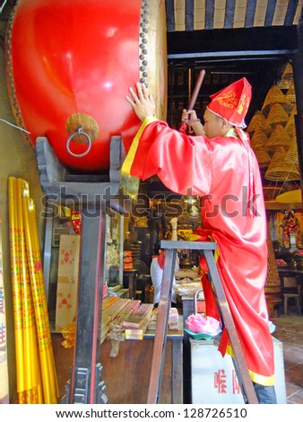 MACAU - SEPTEMBER 19: An unidentified taoist priest hits temple drum during religious ceremony at A-Ma temple on September 19, 2011 in Macau. A-Ma temple is one of the oldest Taoist temples in Macau.