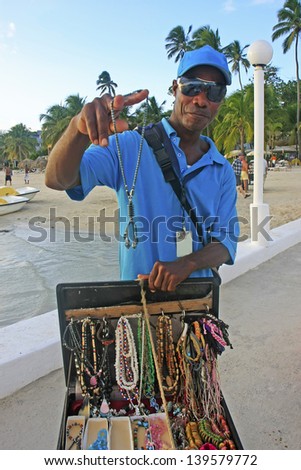 BOCA CHICA, DOMINICAN REPUBLIC-DECEMBER 10: An unidentified man sells jewelry on December 10, 2012 at Boca Chica, Dominican Republic. Boca Chica is the most crowded beach in Dominican Republic.
