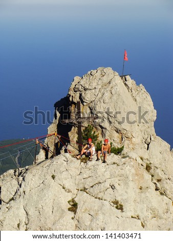 CRIMEA, UKRAINE-SEPTEMBER 3: Unidentified rock climbers walk on a rope on September 3, 2012 at Ai-Petri summit, Crimea, Ukraine. Ai-Petri is one of the peaks of Crimean Mountains over 1200 m.
