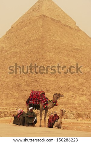 CAIRO, EGYPT-DECEMBER 11: Unidentified men rest near Pyramid of Khafre on December 11, 2010 in Cairo, Egypt. Great Pyramids are the oldest of the ancient Wonders and the only one still in existence.
