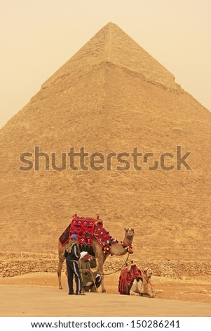 CAIRO, EGYPT-DECEMBER 11: Unidentified men rest near Pyramid of Khafre on December 11, 2010 in Cairo, Egypt. Great Pyramids are the oldest of the ancient Wonders and the only one still in existence.