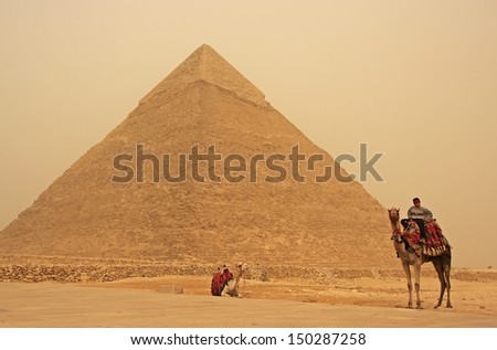 CAIRO, EGYPT-DECEMBER 11: Unidentified man sits on camel near Pyramid of Khafre on December 11, 2010 in Egypt. Great Pyramids are the oldest of the ancient Wonders and the only one still in existence.