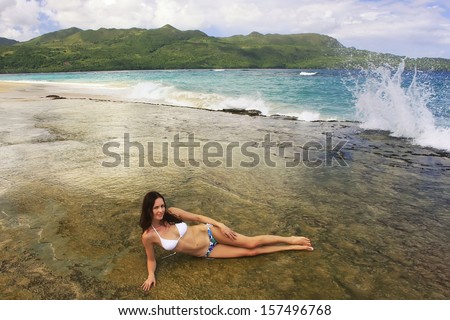 Young woman in bikini laying at Rincon beach, Samana peninsula, Dominican Republic